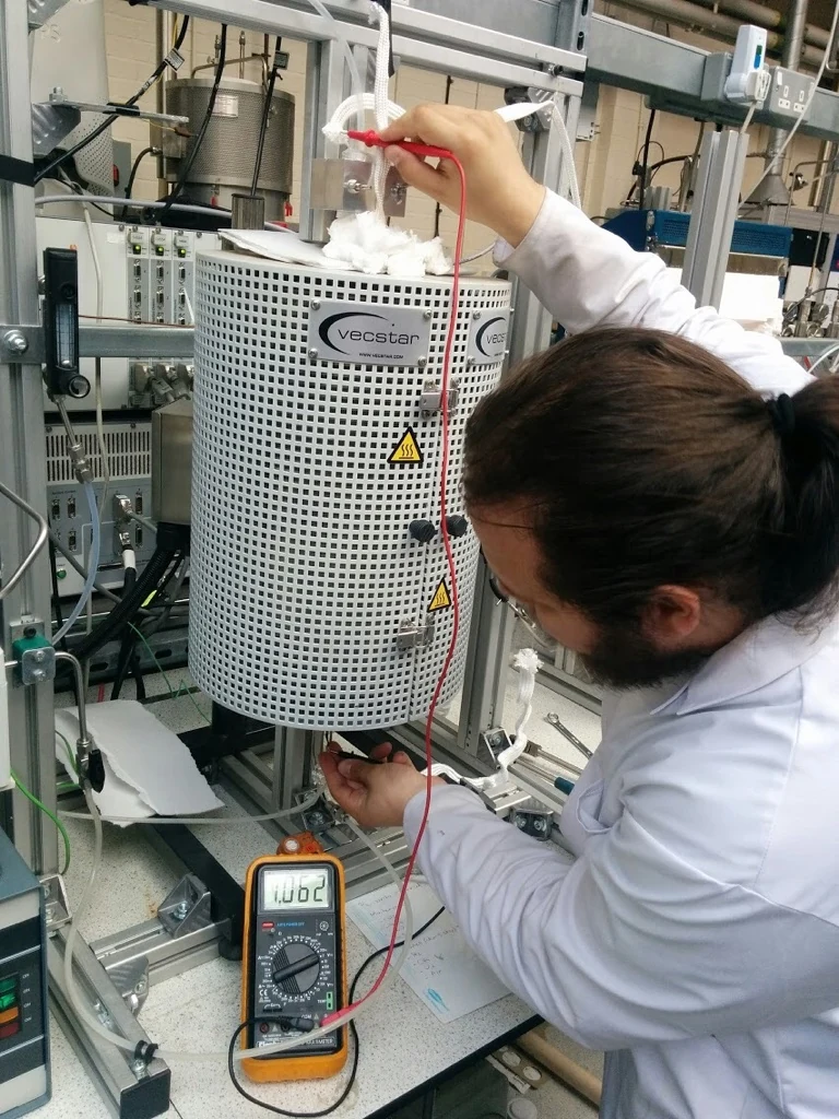 Researcher carrying out measurements on a high-temperature laboratory setup
